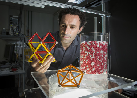 Mohammad Saadatfar holds a physical model of a molecule illustrating the packing study.