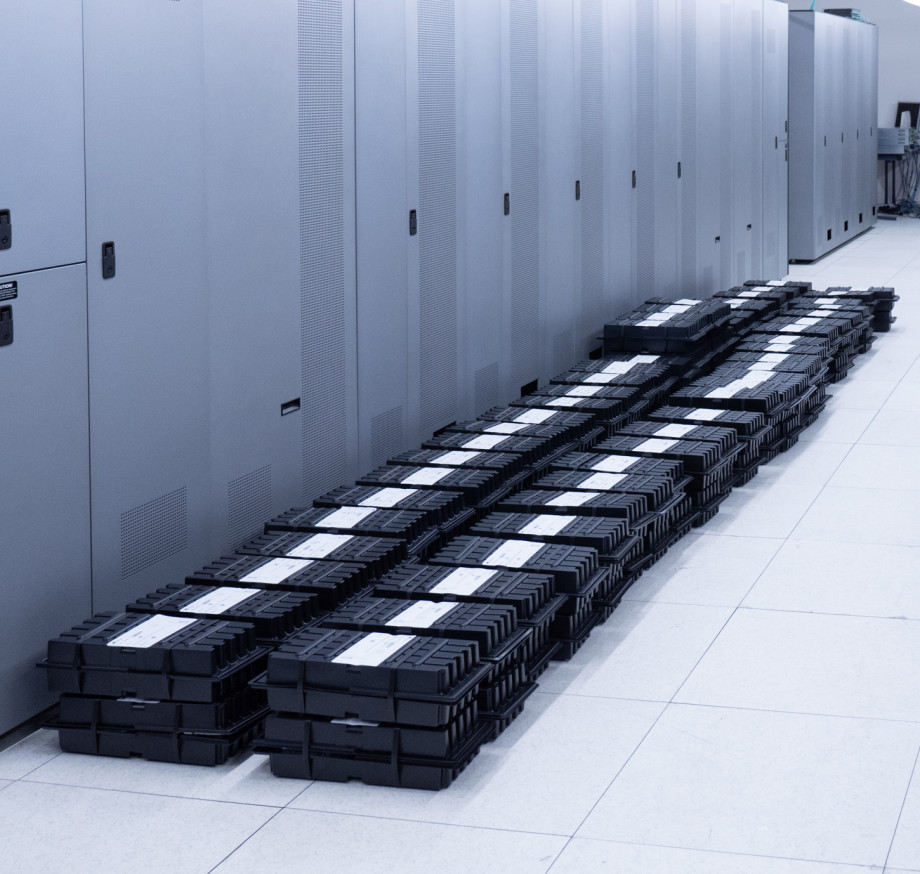 Hard drives stacked along a wall.