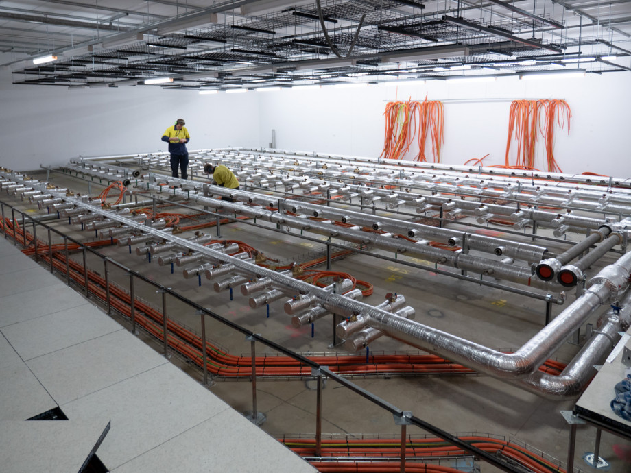 The floor tiles removed from the data centre reveal the plumbing underneath.