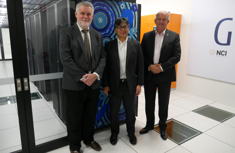 Delegates standing in front of the Gadi supercomputer