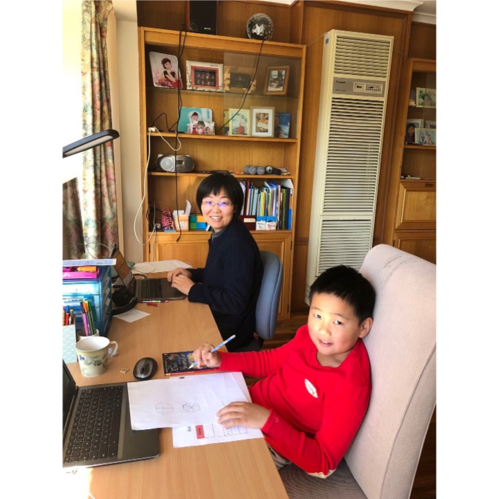 Dr Jingbo Wang and her son, working together at a desk