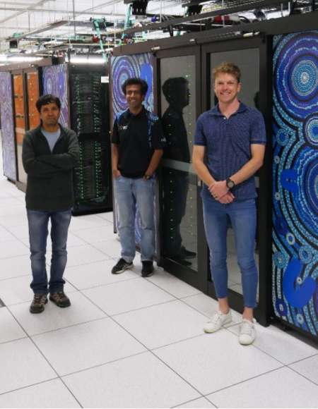 The NCI User Support Team standing next to the Gadi supercomputer
