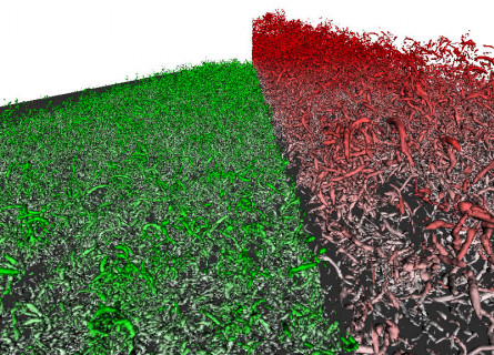 Two interacting turbulent fluids showing green and red masses of twisted vortices.