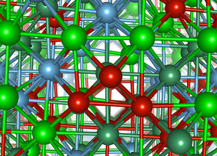 Atomistic model of the NbTiVZr high-entropy alloy showing many connected red, green, blue and dark green spheres.balls
