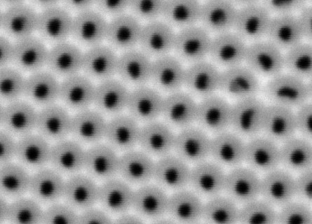 Close-up image of a nanoporous membrane approximately 600 nanometres wide with regularly spaced holes in a hexagonal grid.