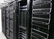 Silver and black storage equipment stacked together in tall racks.