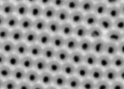 Close-up image of a nanoporous membrane approximately 600 nanometres wide with regularly spaced holes in a hexagonal grid.