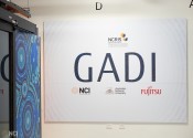 A big white panel on the walll with Gadi written in large letters above some logos.