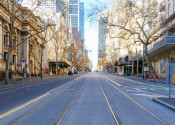 Looking down the middle of an empty street in Melbourne, with no cars and no trams on the tracks.