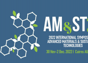 Logo for AM&ST 22 Symposium, white words saying "2022 International Symposium on Advanced Materials and Sustainable Technologies". There is a white grid of hexagons on the left with leaves growing off it.