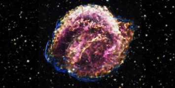 A purple, gold and pink ball of gas on a fuzzy black sky background filled with stars.
